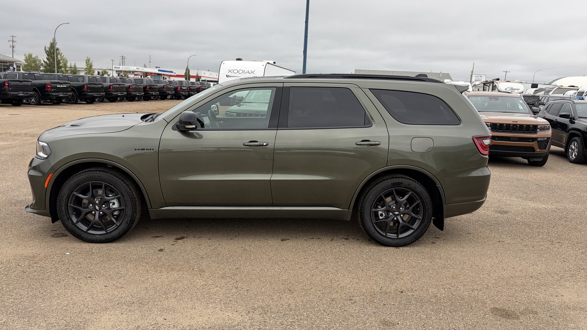 A green Dodge Durango SUV parked on a dealership lot